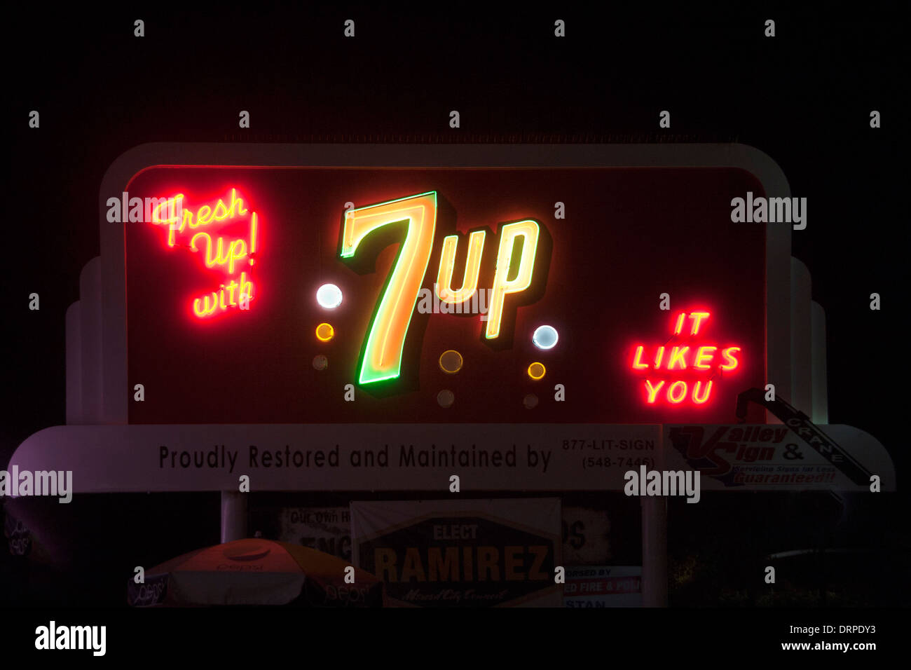 The soft drink 7 Up is advertised on an illuminated outdoor sign in Merced, CA, part  program to preserve historic signs. Stock Photo