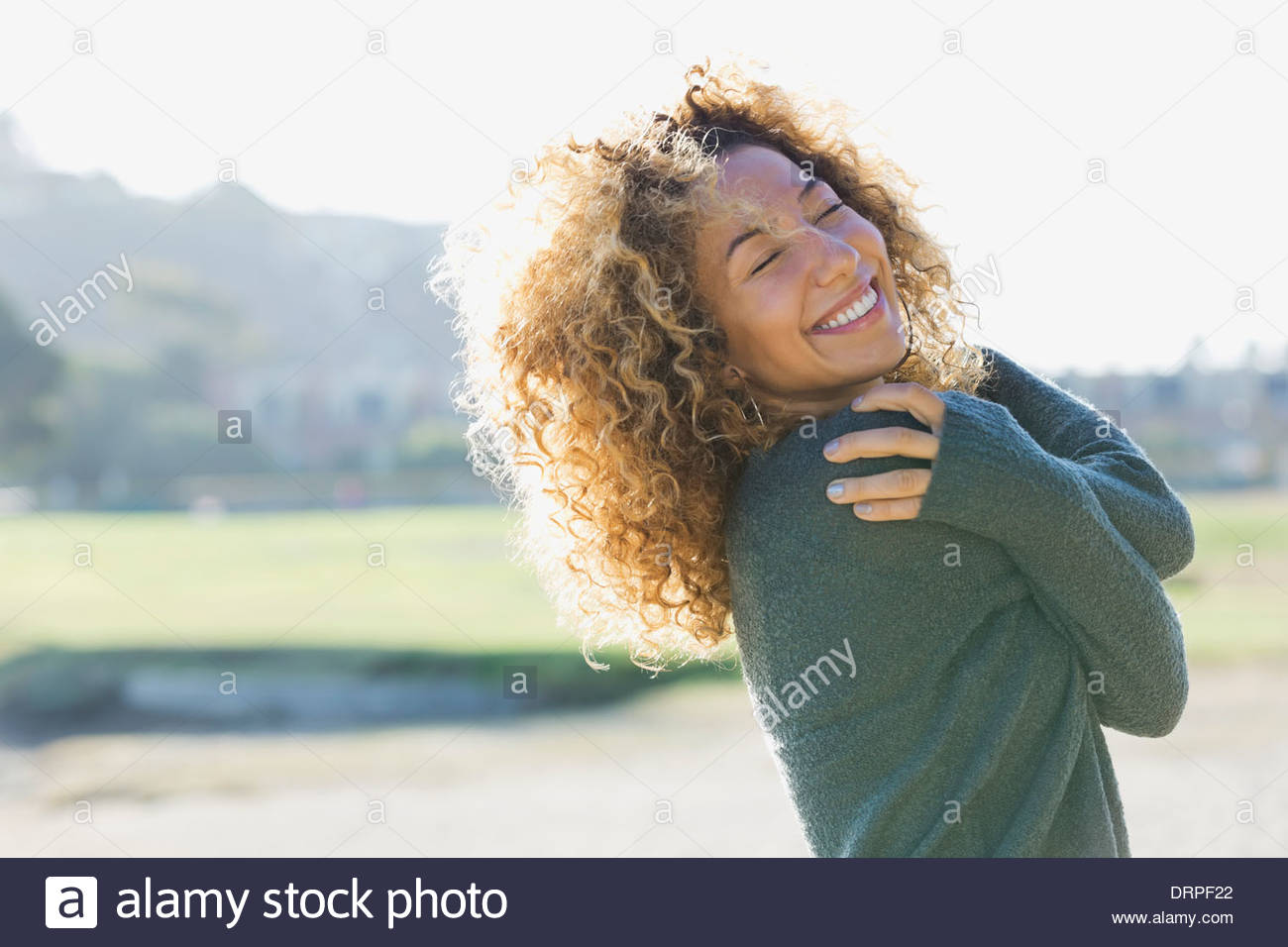 Smiling woman with eyes closed outdoors Stock Photo