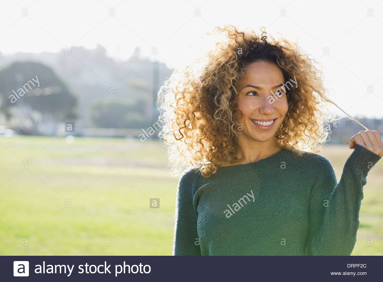 Woman playing with hair outdoors Stock Photo
