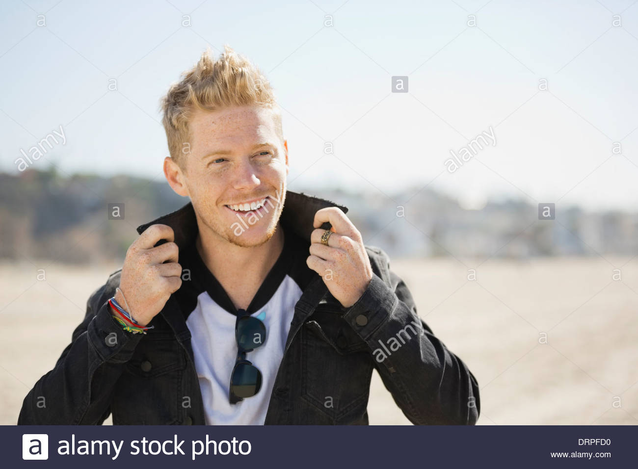 Fashionable man standing on beach Stock Photo