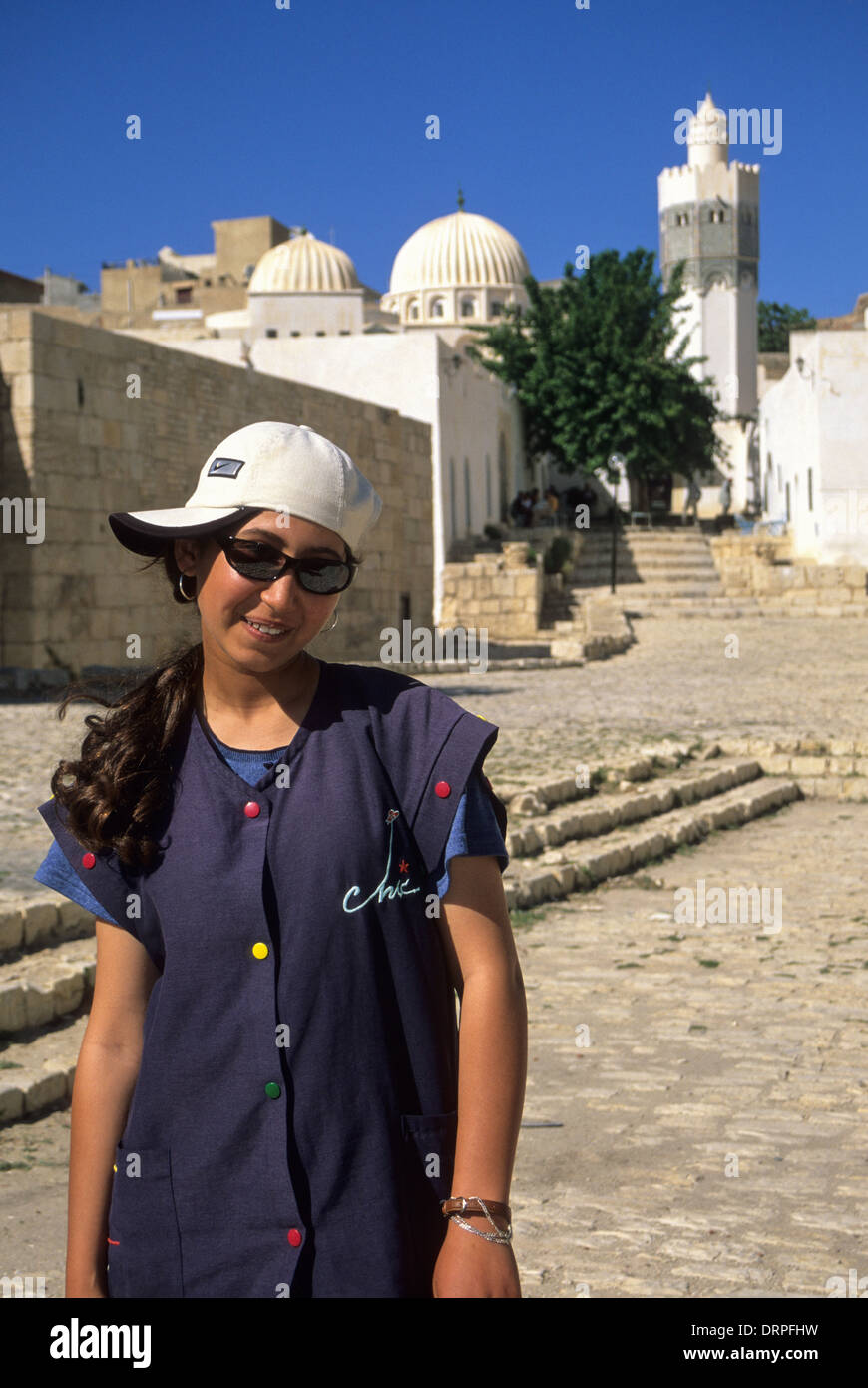 Tunisia, Le Kef. Fourteen-year-old Tunisian Girl, Boumakhlouf Mosque in Background. Stock Photo