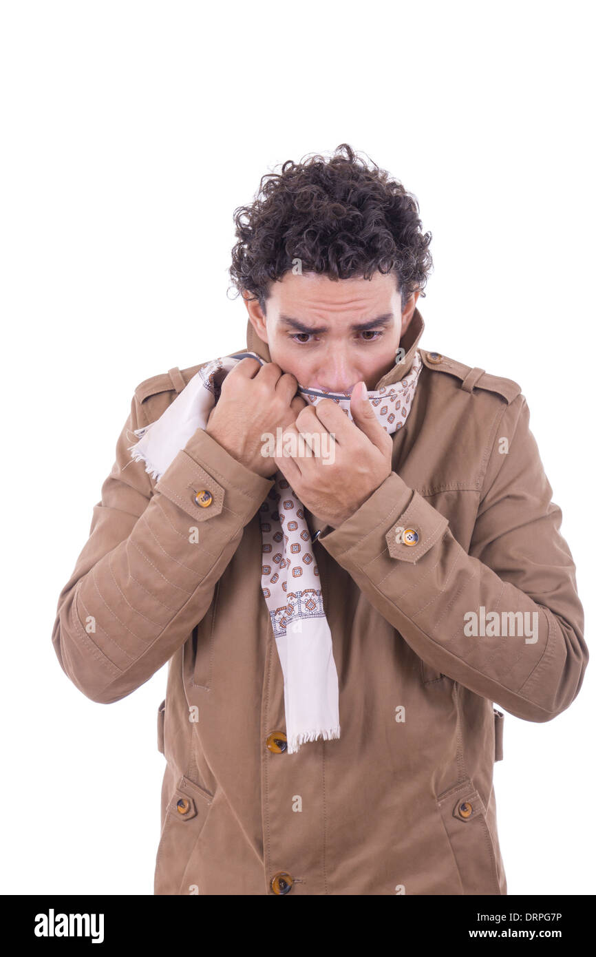 adult man in the coat covers the face with scarf against the coldness Stock Photo