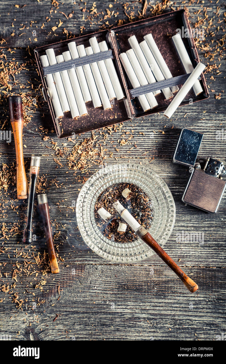 Cigarettes, ashtray and a smoking pipe Stock Photo