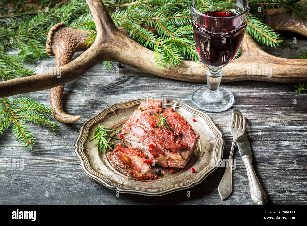 Roasted venison served with red wine Stock Photo Alamy