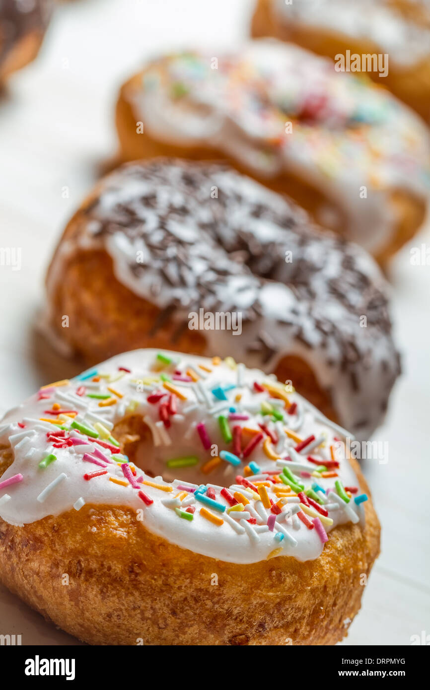 Closeup of freshly baked colorful donuts Stock Photo - Alamy