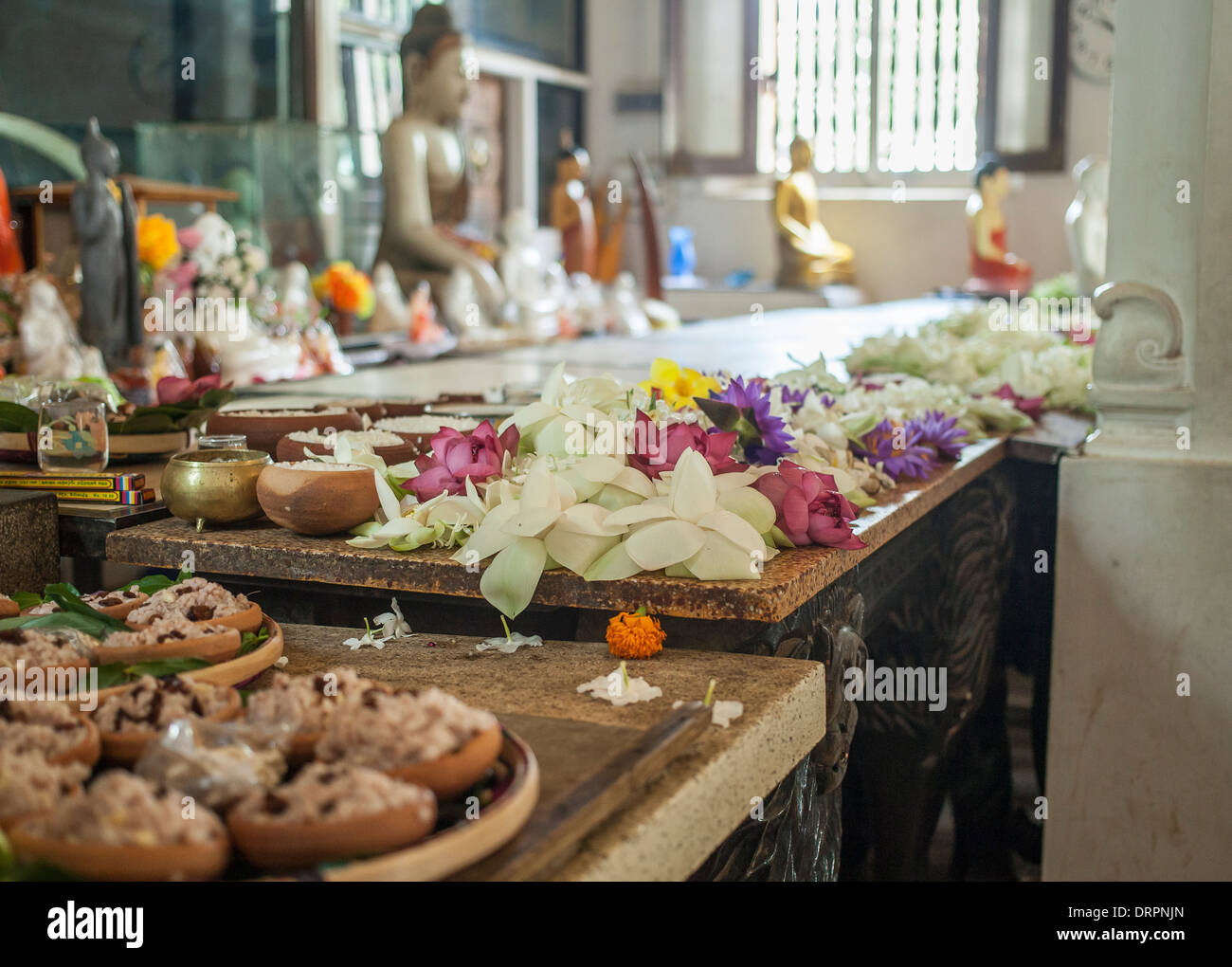 Flower offerings inside a buddhist temple Stock Photo