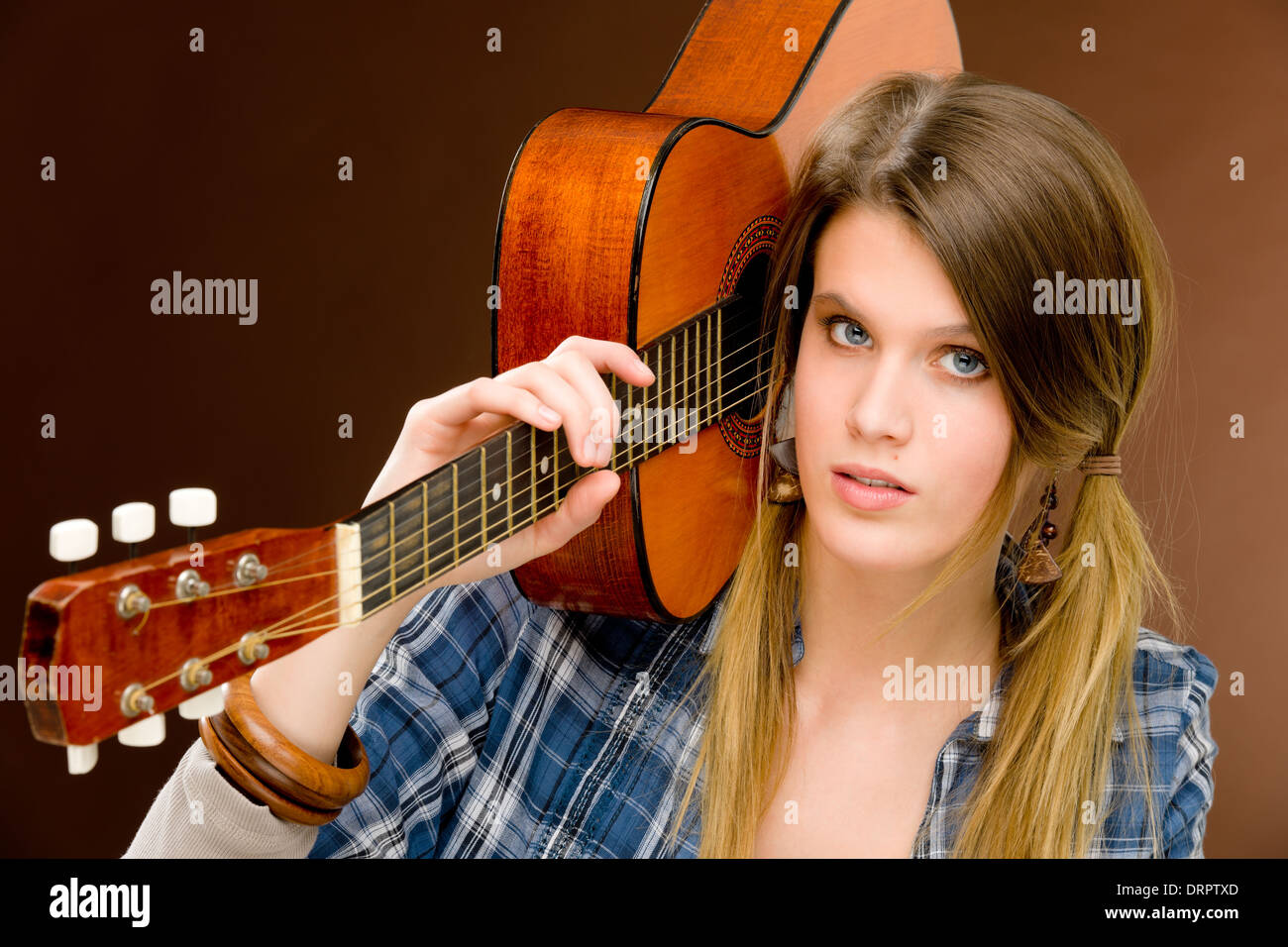 Rock musician - fashion woman holding guitar Stock Photo - Alamy