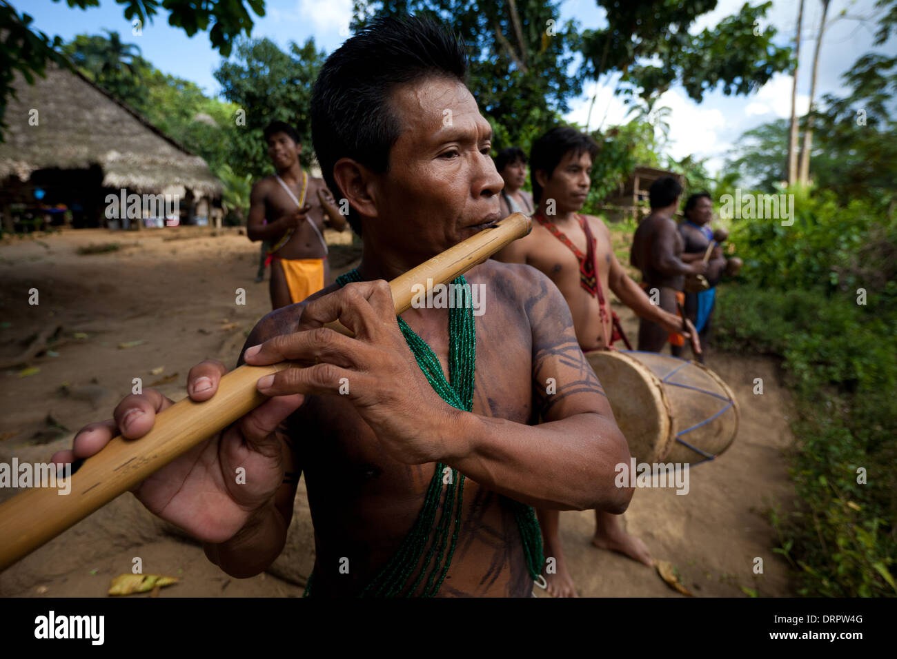 Embera indian men playing traditional music in their village beside Rio Pequeni, Panama/Colon province, Republic of Panama, Central America. Stock Photo