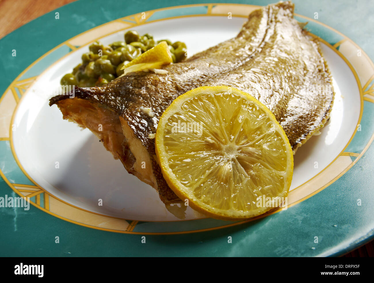 Baked Flounder with vegetables and lemon Stock Photo Alamy