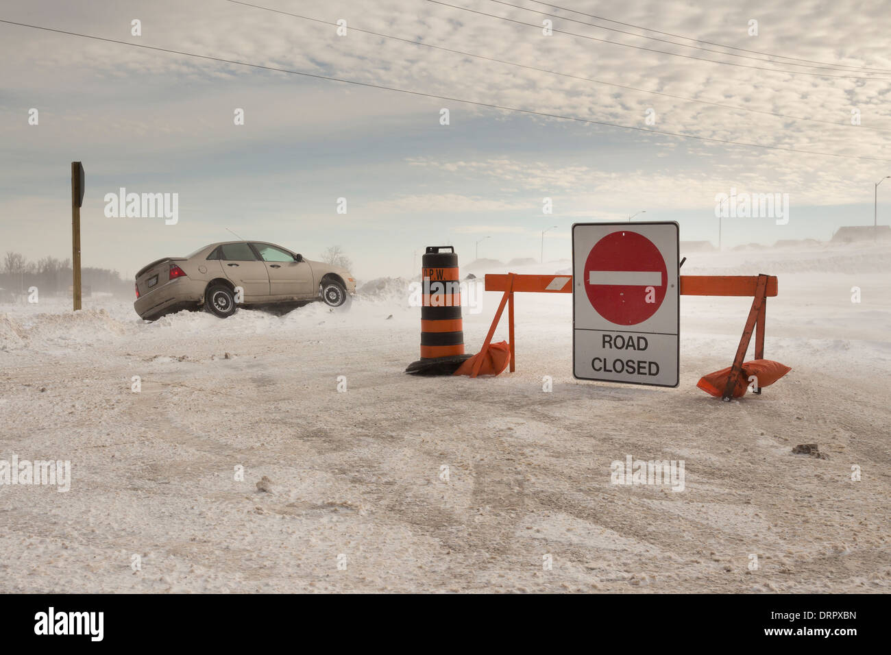 Orangeville Police close a road after a car slides into ditch due to poor winter weather and local whiteout blizzard conditions Stock Photo