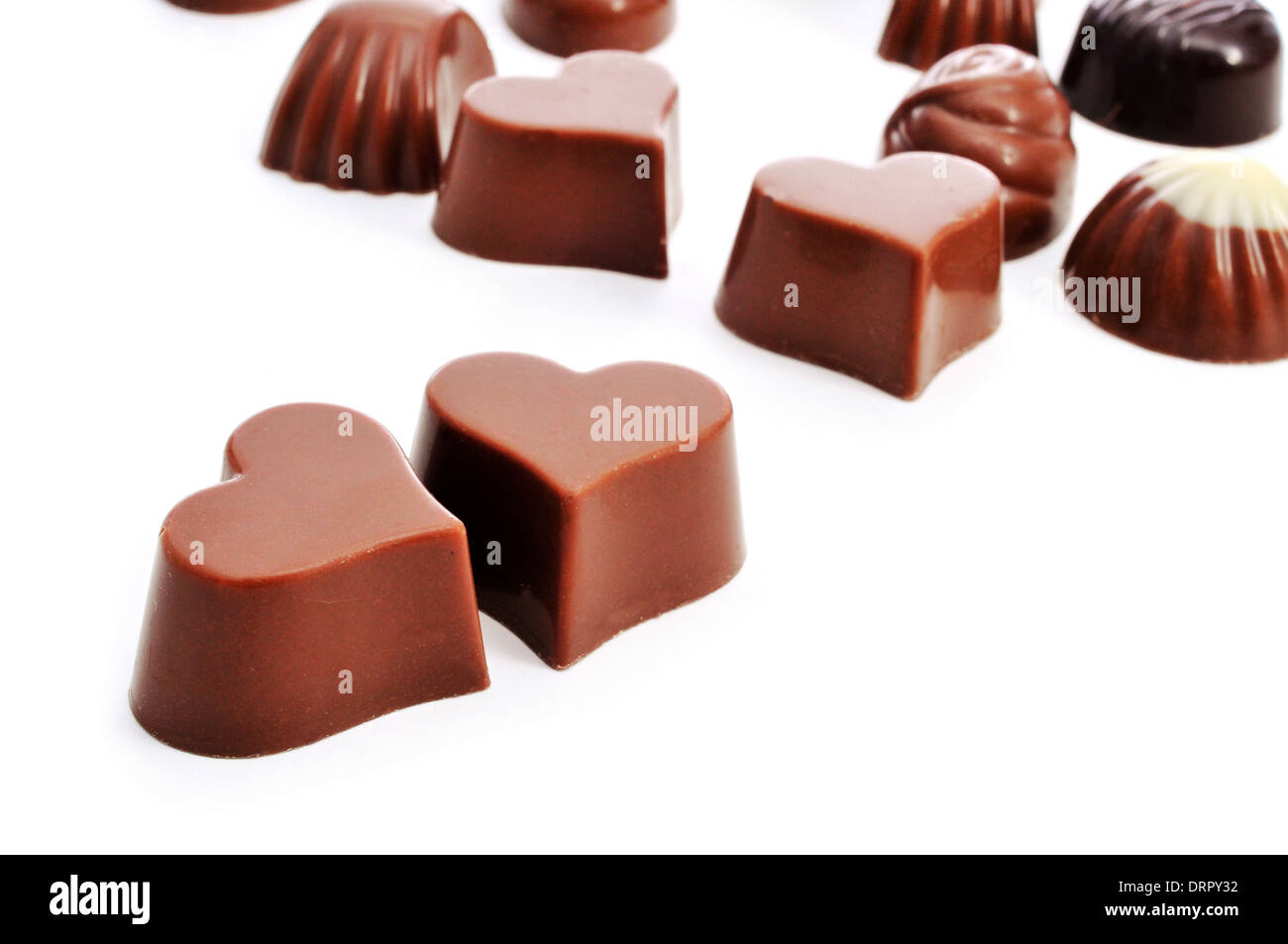 closeup of some heart-shaped chocolate bonbons on a white background Stock Photo