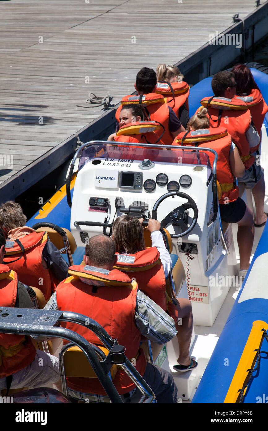 Group of Visitors in Life Vests on boat going for Excursion at waterfront, Cape Town - South Africa Stock Photo