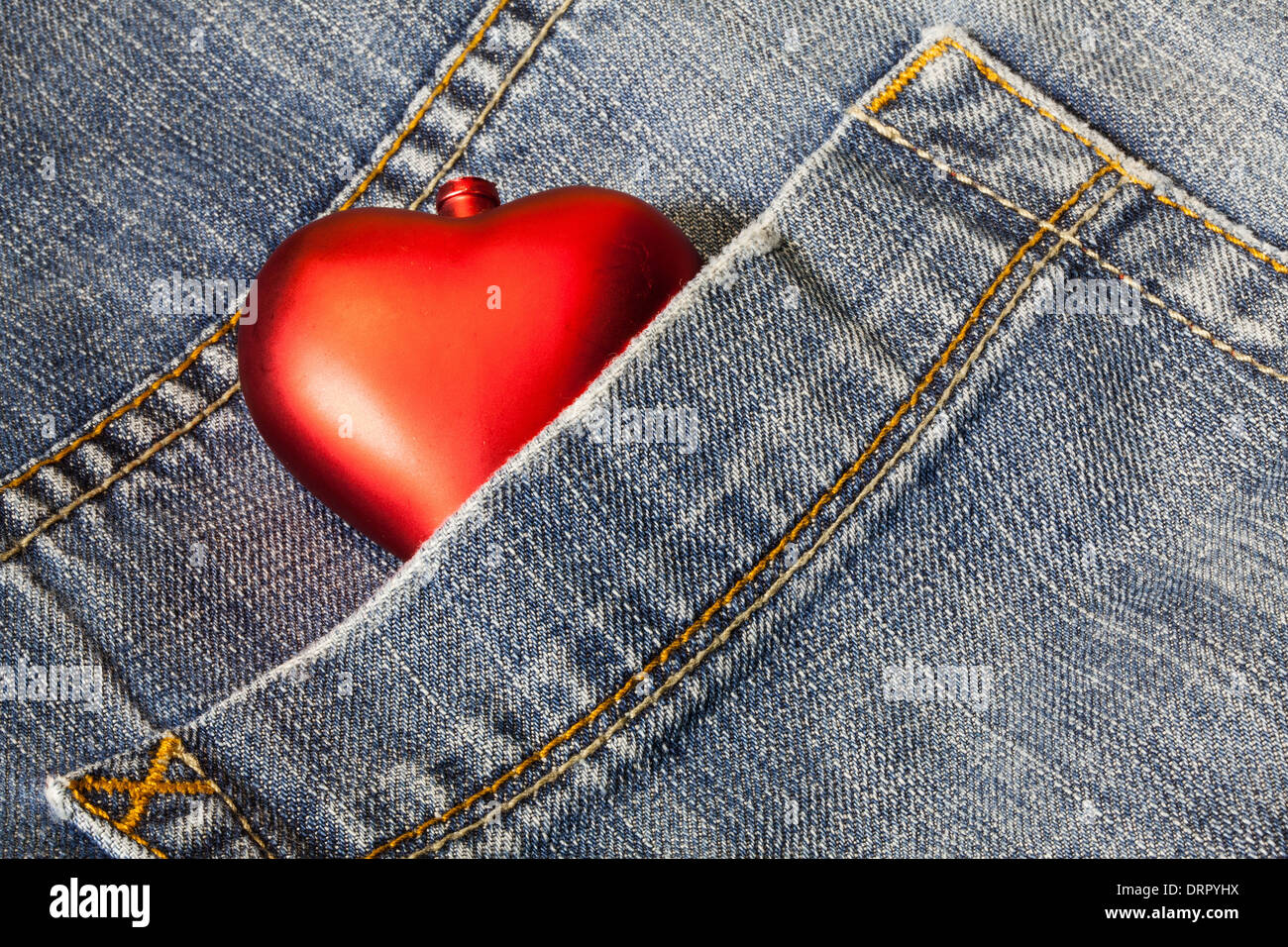 Red heart in blue jeans Stock Photo Alamy