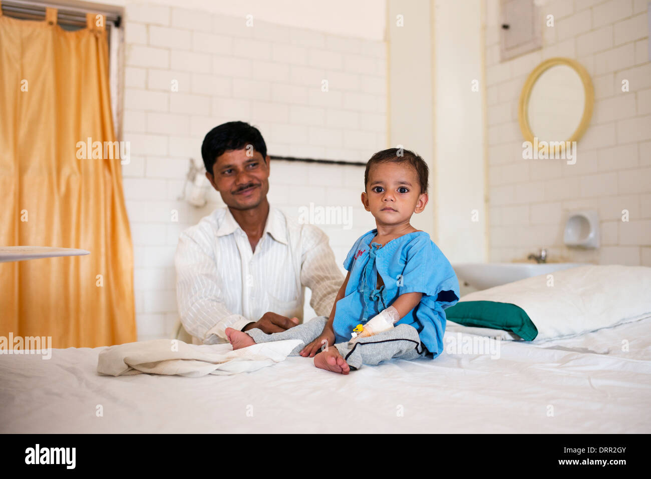 Young Indian boy heart patient and father in the Sathya Sai Baba Super Speciality hospital. Puttaparthi, Andhra Pradesh, India Stock Photo