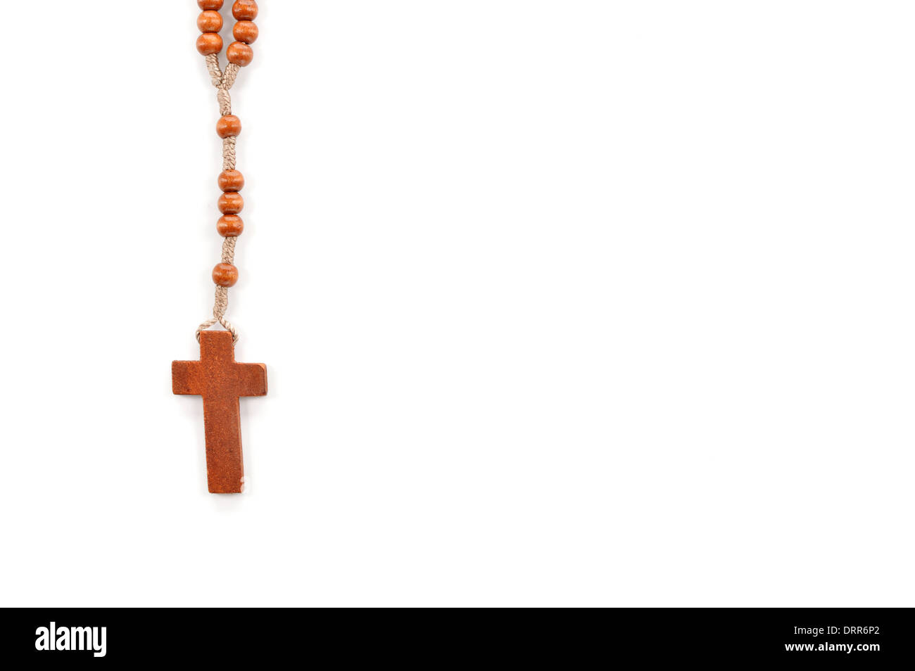 Wooden plain rosary on white background. Prayer beads use to count the repetitions of prayers - rosary of Virgin Mary. Stock Photo