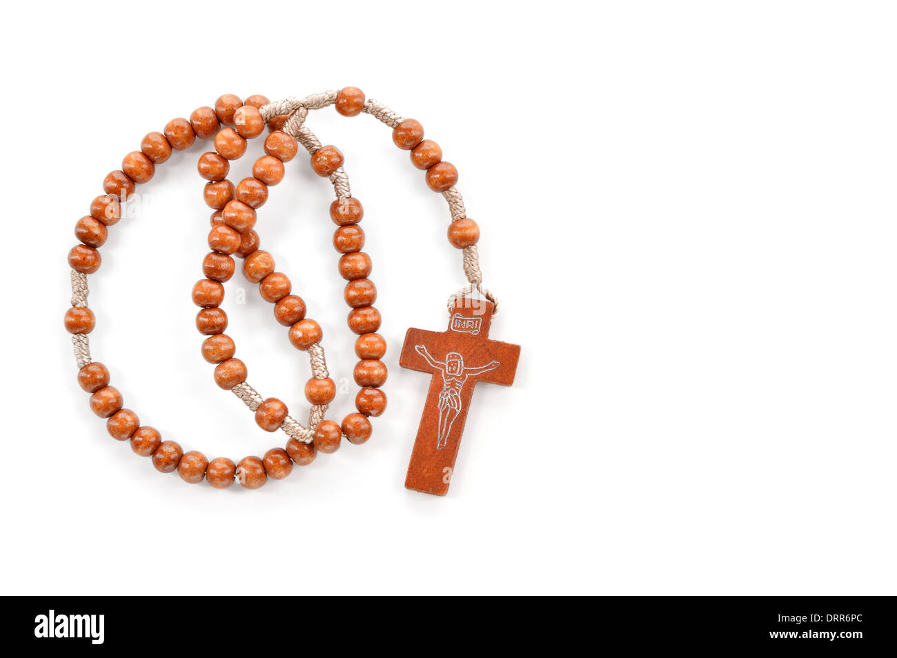 Wooden plain rosary on white background. Prayer beads use to count the repetitions of prayers - rosary of Virgin Mary. Stock Photo