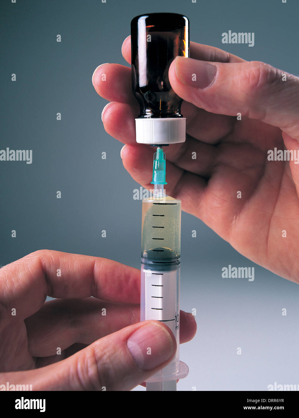 Doctor filling syringe Stock Photo