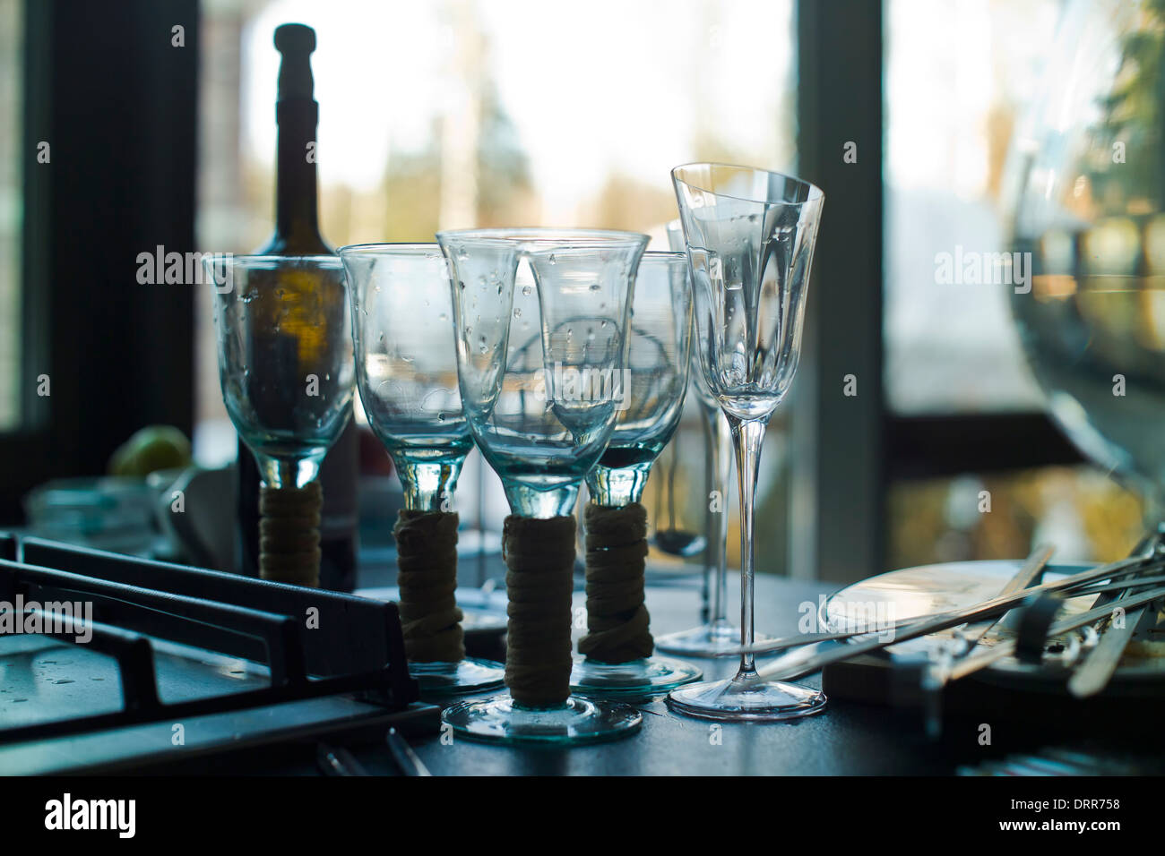 dirty dish ware and leftovers, wine glasses  on  the table Stock Photo