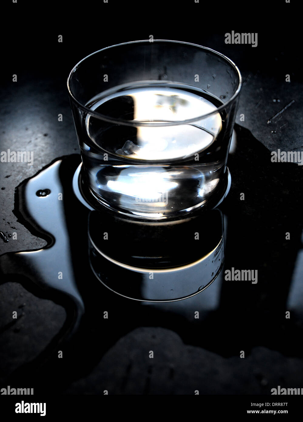 Reflections Of Water Spilled From A Glass Stock Photo - Alamy