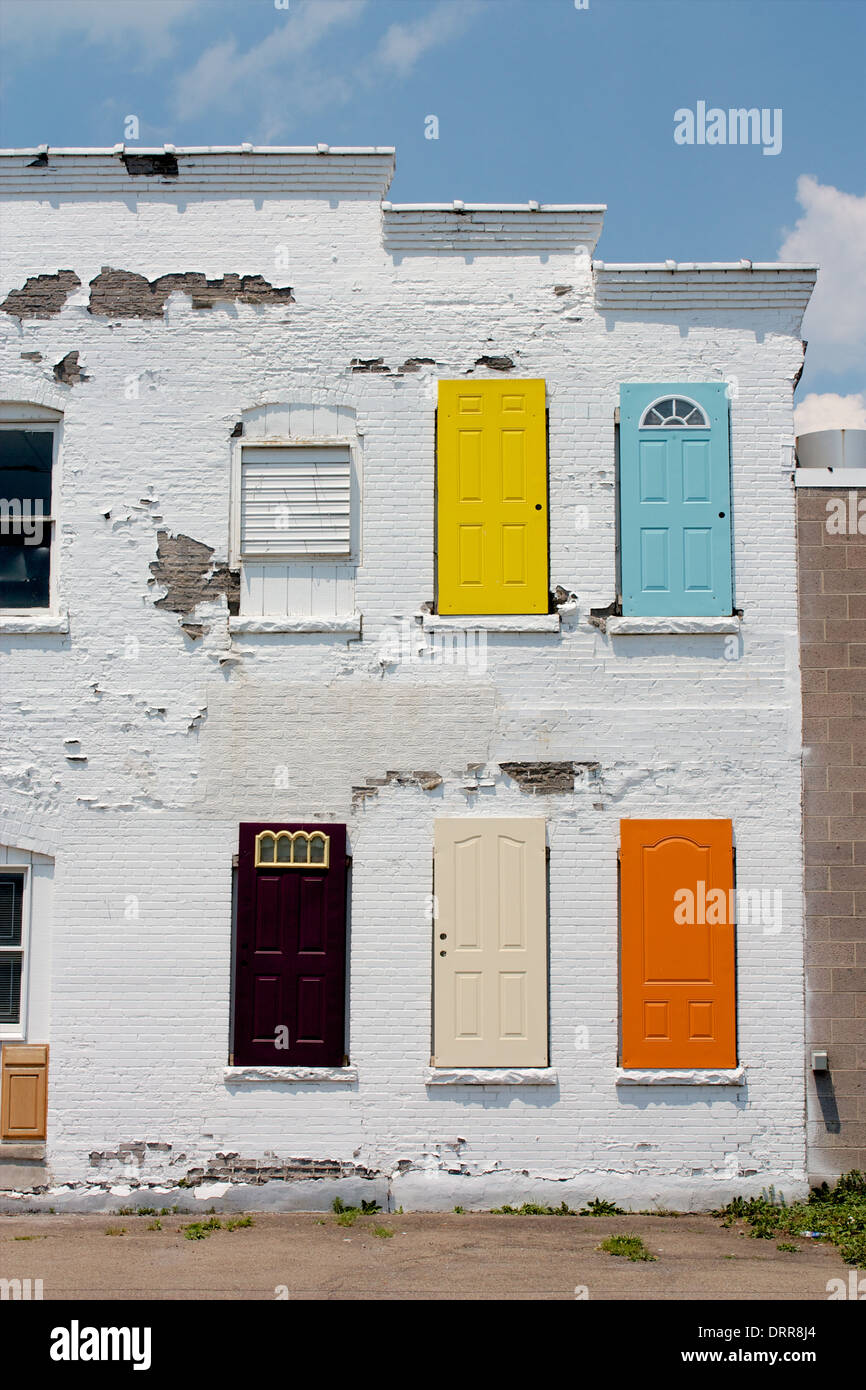 Doors in the side of a white brick building. Stock Photo