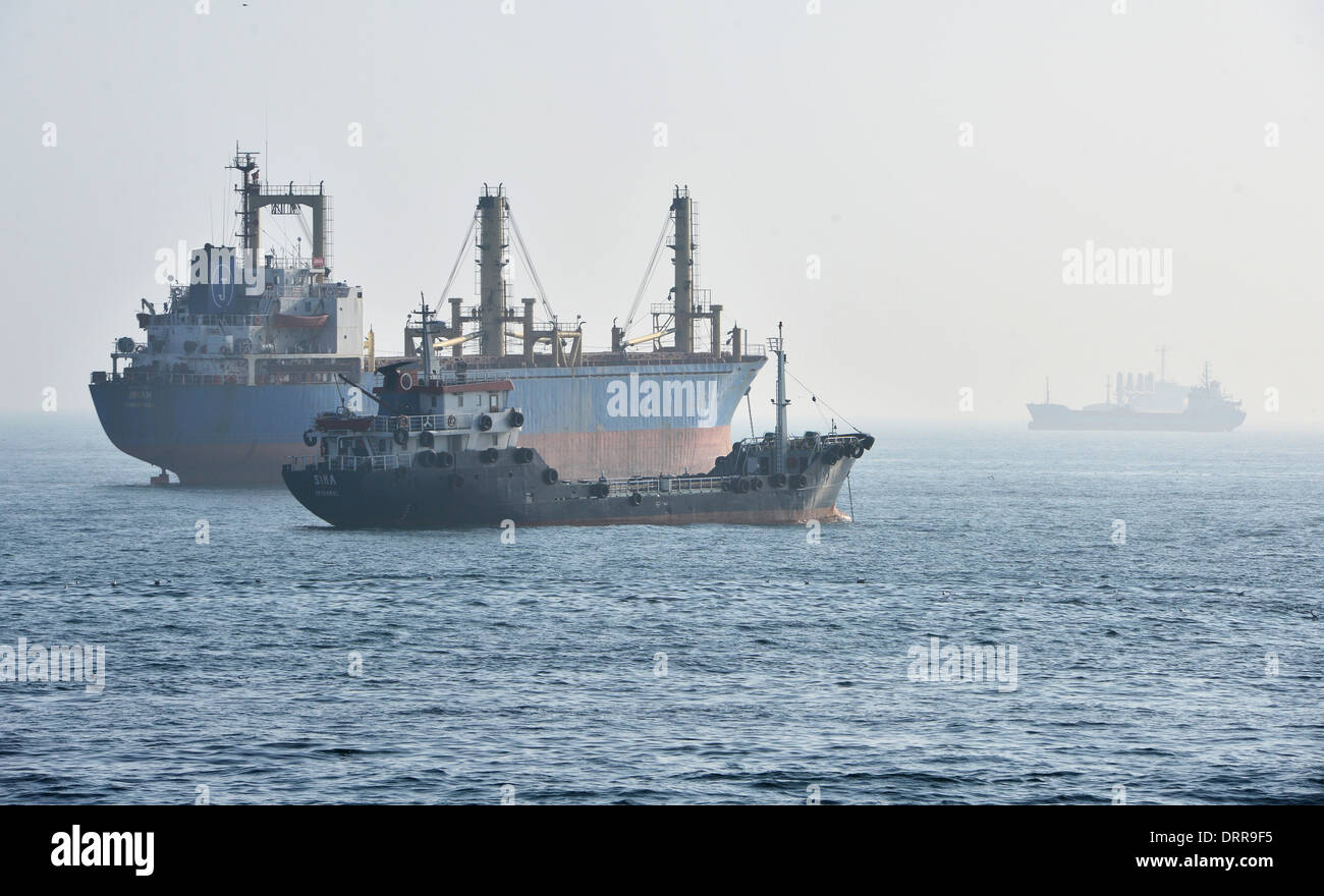 sea cargo ship and oil tanker in the fog Stock Photo