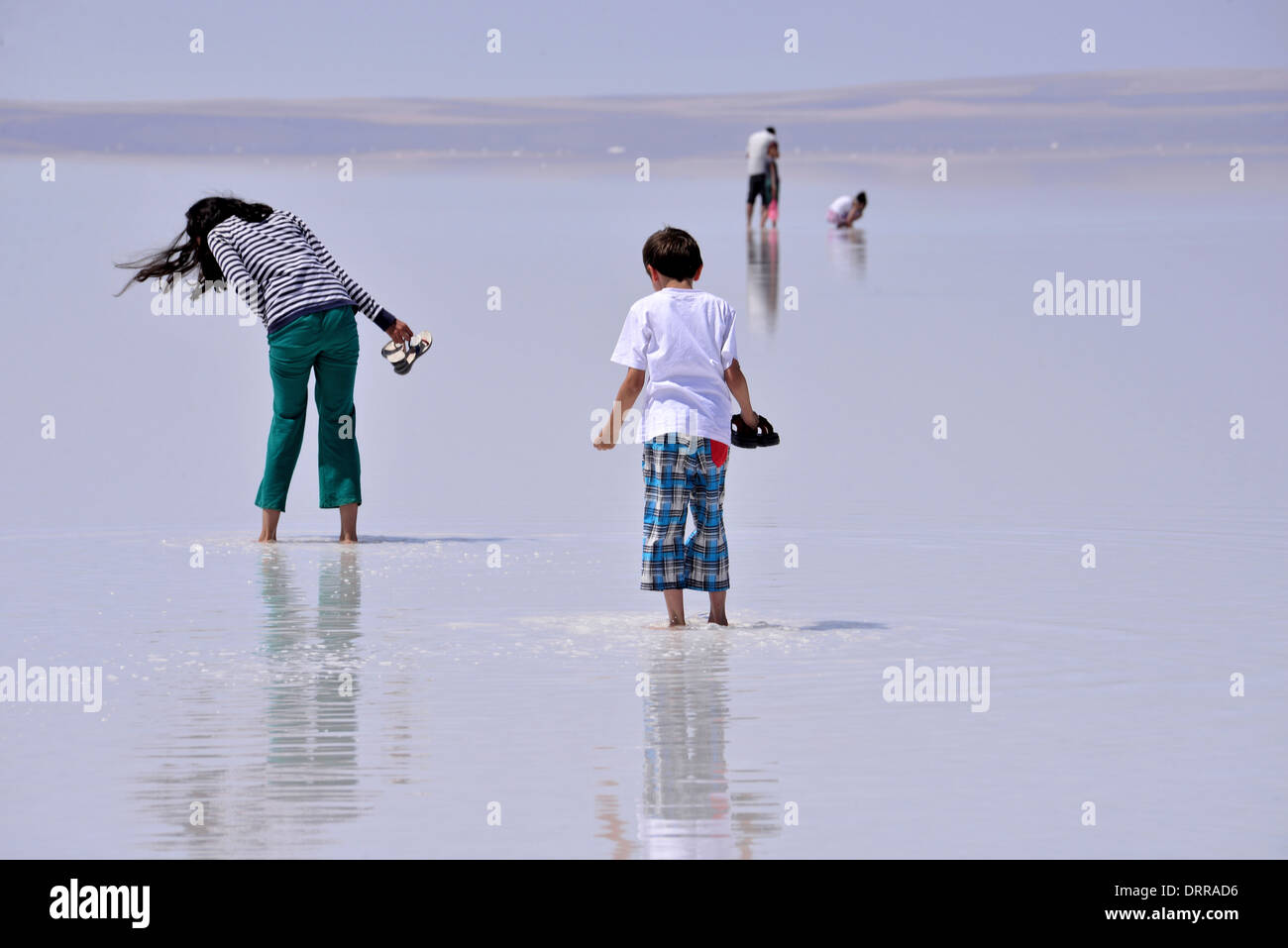 SALT LAKE, TURKEY - JULY 03: People walking at Salt Lake on July 03, 2013 in Aksaray, Turkey. Stock Photo