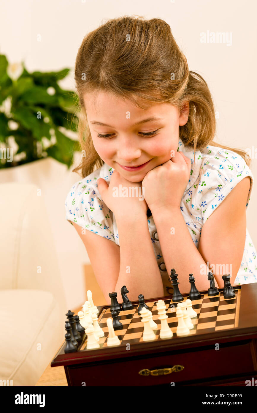 Young girl play chess cute smile Stock Photo