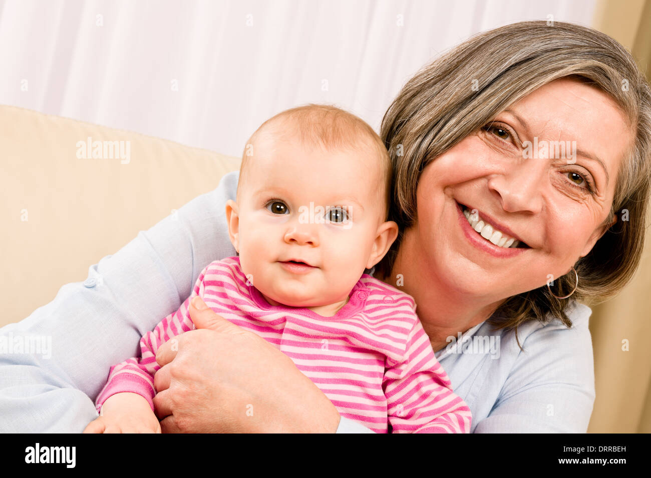 Grandmother hold little baby girl smiling Stock Photo - Alamy