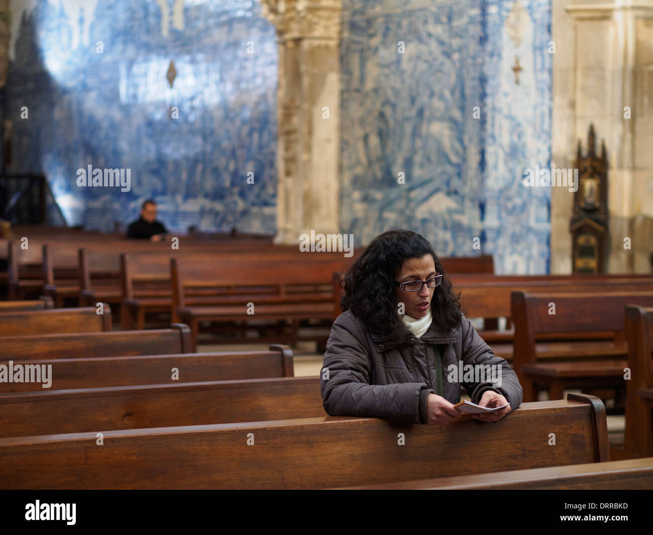 Woman praying in church Stock Photo