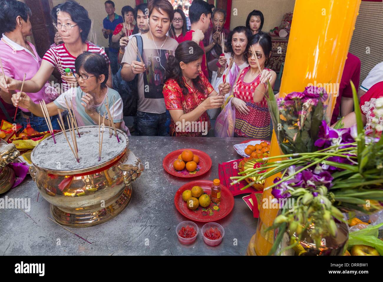 Bangkok, Thailand. 31st Jan, 2014. People pray at Wat Mangkon Kamalawat during Lunar New Year festivities, also know as Tet and Chinese New Year, in Bangkok. This year is the Year of the Horse. Credit:  Jack Kurtz/ZUMAPRESS.com/Alamy Live News Stock Photo
