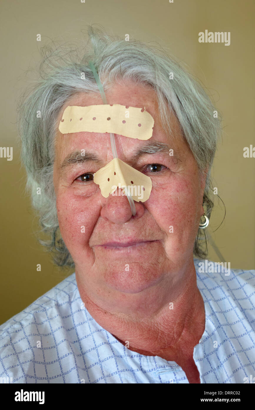 Portrait of elderly patient in hospital with oxygen tube in her nose Stock Photo