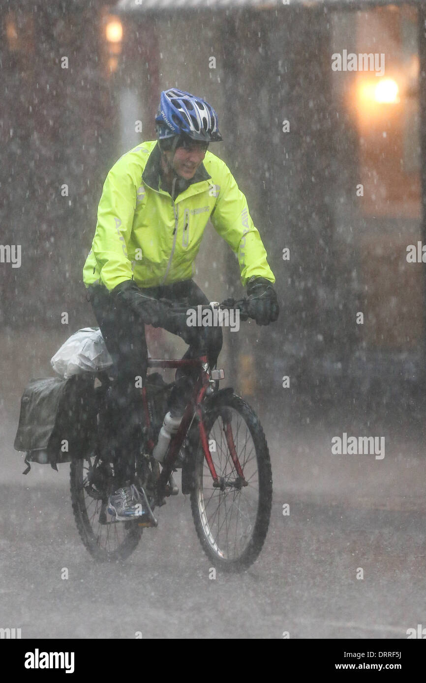 MAN ON BIKE IN RAIN IN CAMBRIDGE Stock Photo Alamy