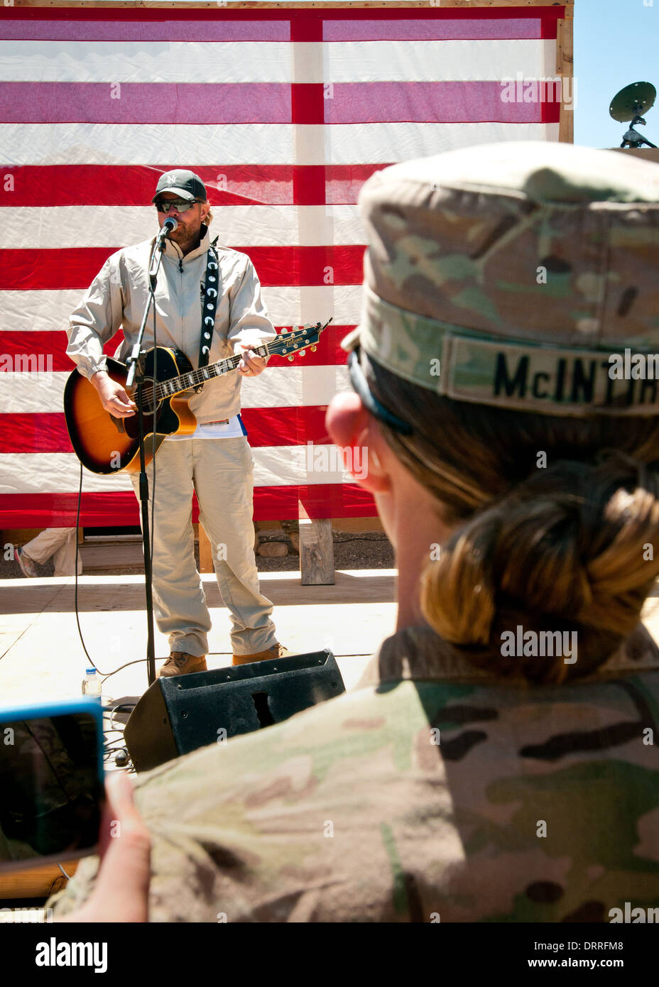 Country music singer songwriter Toby Keith performs for the troops during a surprise concert April 29, 2012 at Forward Operating Base Sharana in Paktika province, Afghanistan. Stock Photo