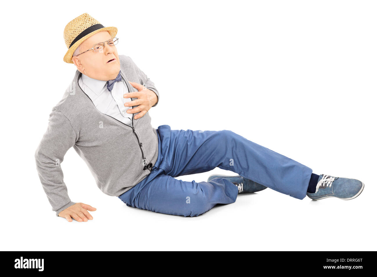 Middle aged gentleman laying on the ground having a heart attack Stock Photo