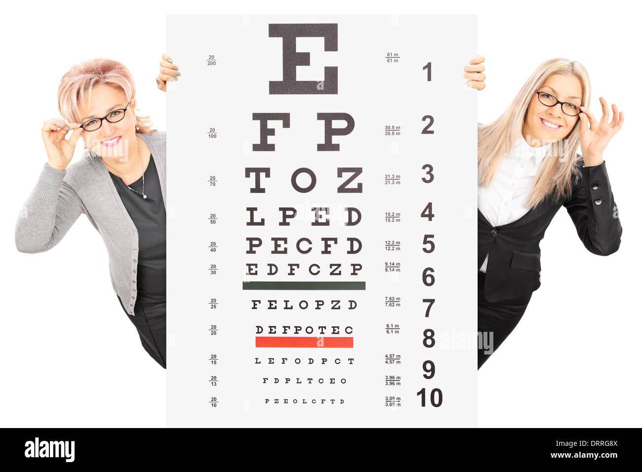 Young woman and a mature lady with glasses standing behind eyesight test Stock Photo