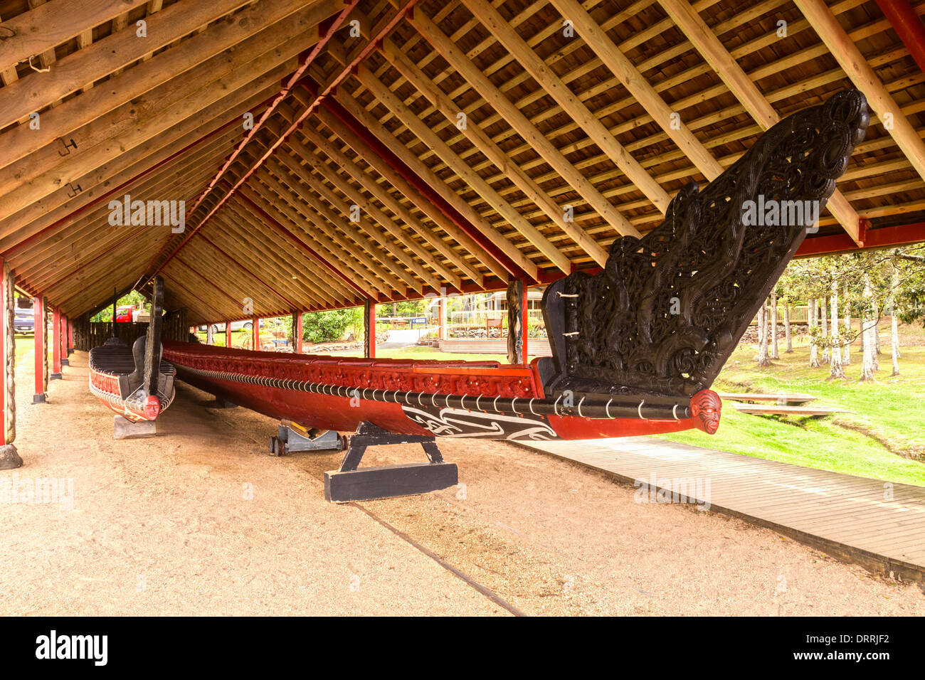 The traditionally styled boathouse on the Waitangi Treaty Grounds, Northland, New Zealand, houses two waka (canoes)... Stock Photo