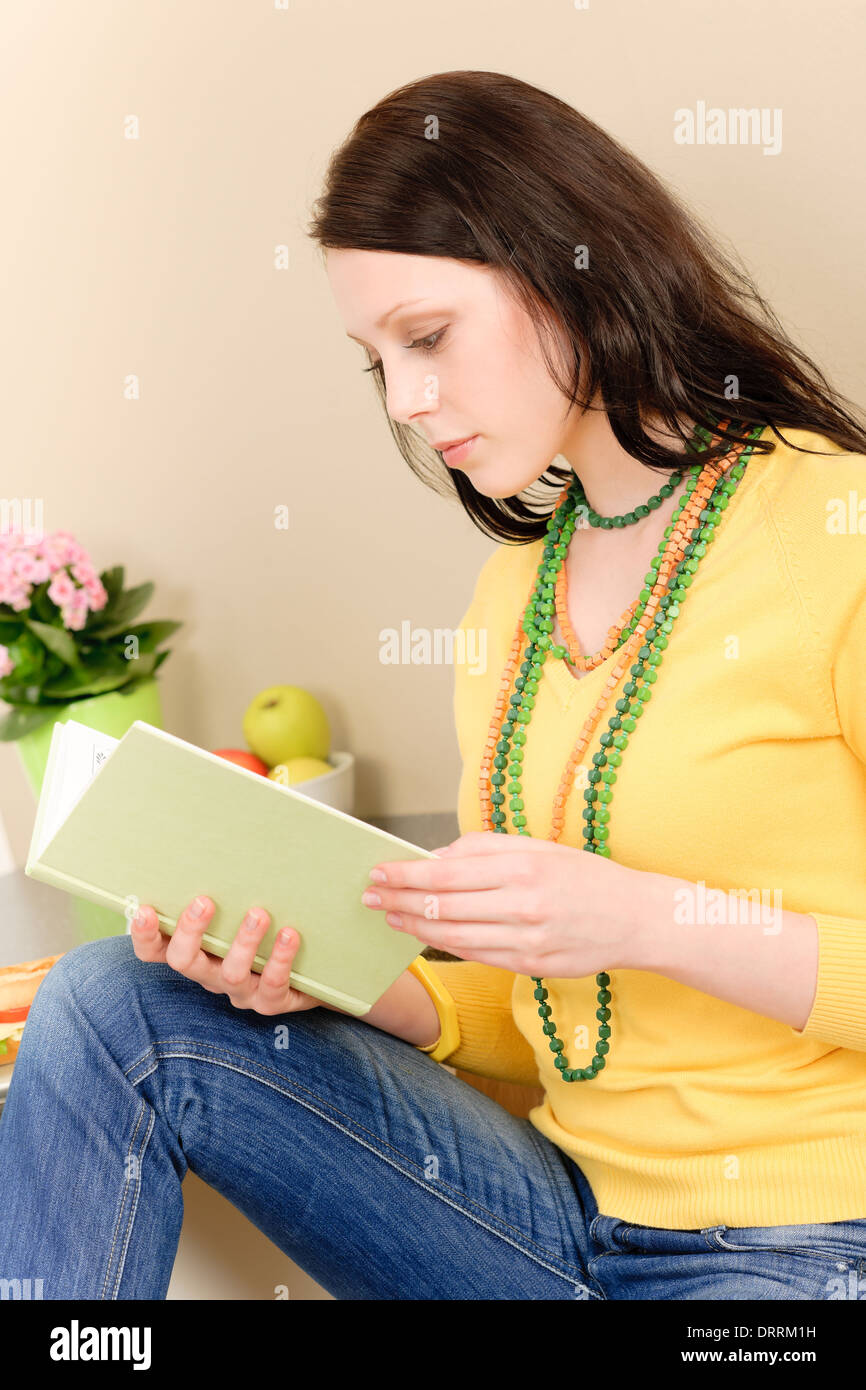 Young student girl reading book at home Stock Photo - Alamy