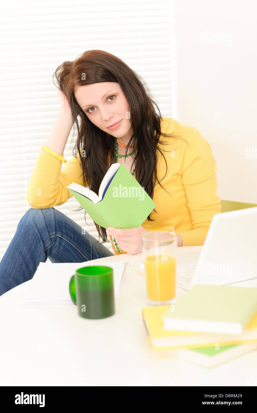 Young student girl reading book at home Stock Photo - Alamy