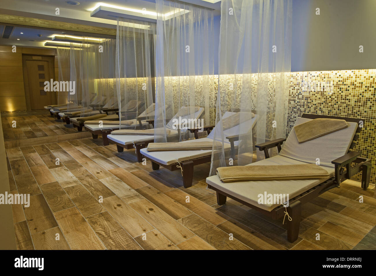 Relaxation area insode a luxury health spa with beds and towels Stock Photo