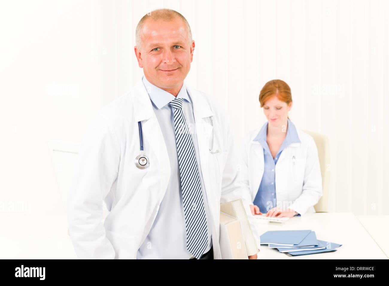 Medical team senior male doctor young woman Stock Photo