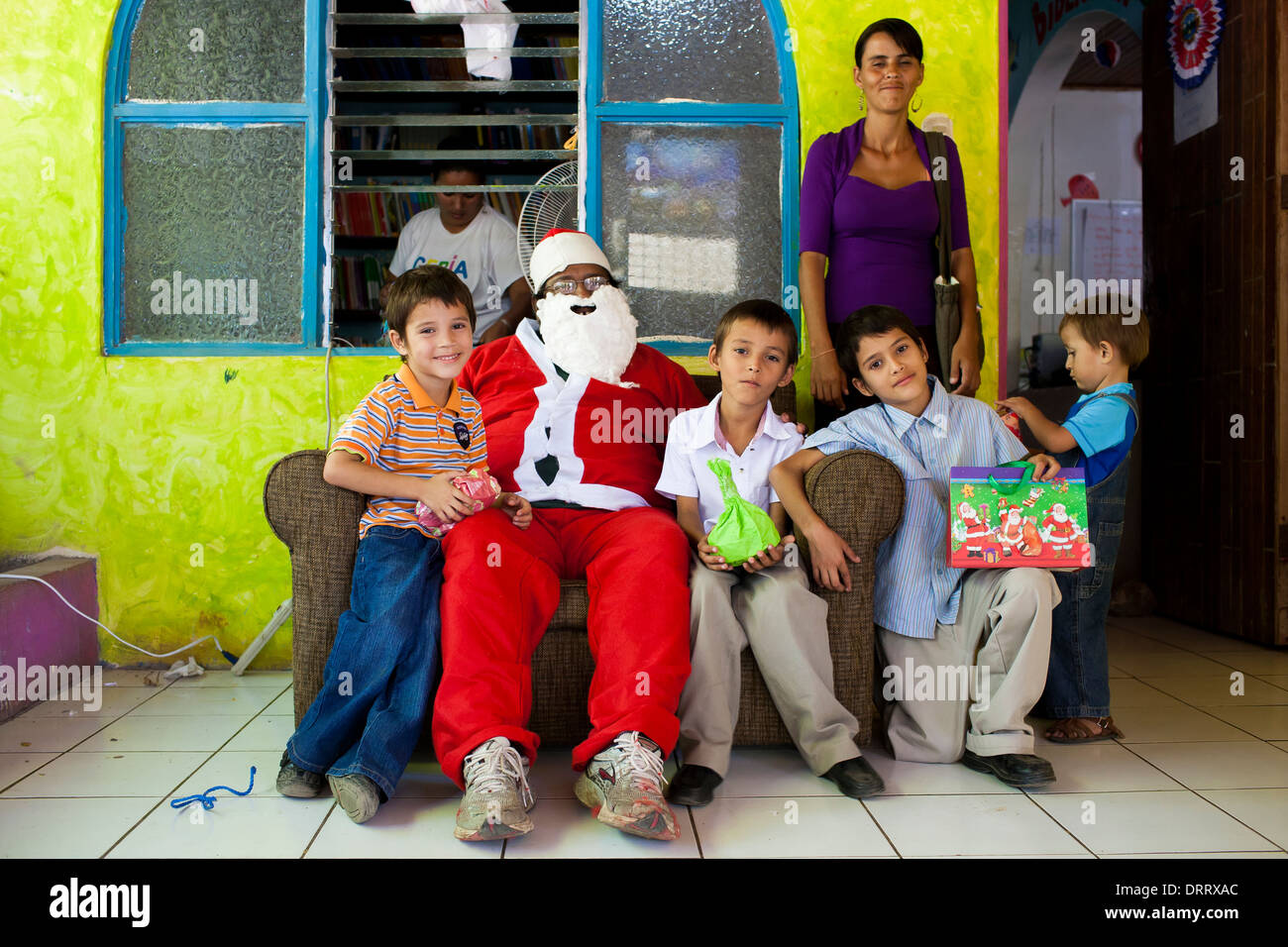 A poor family receives a gift from father Christmas donated by the