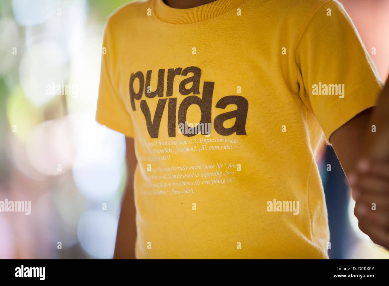 A young boy wears a tee shirt that reads 'Pura Vida', a classic Costa Rican phrase meaning 'pure life' in Huacas, Costa Rica Stock Photo