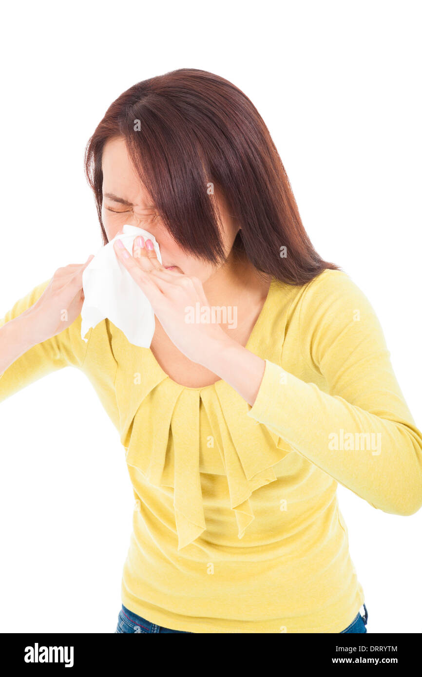 young woman using a tissue and blowing nose Stock Photo