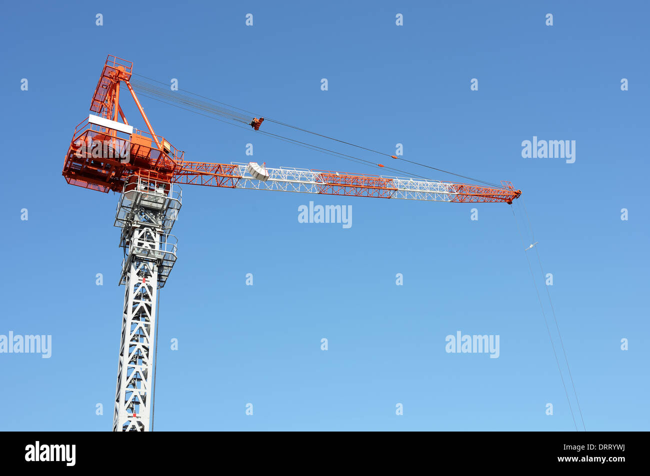 Building jib crane against a clear blue sky Stock Photo Alamy