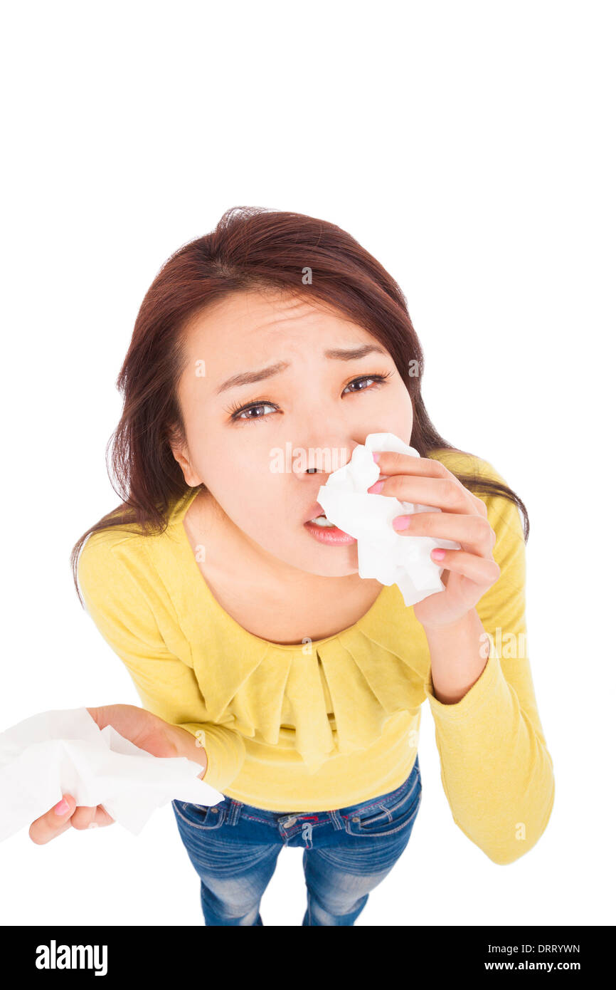 Sneezing and blowing nose, young woman struggles with cold Stock Photo