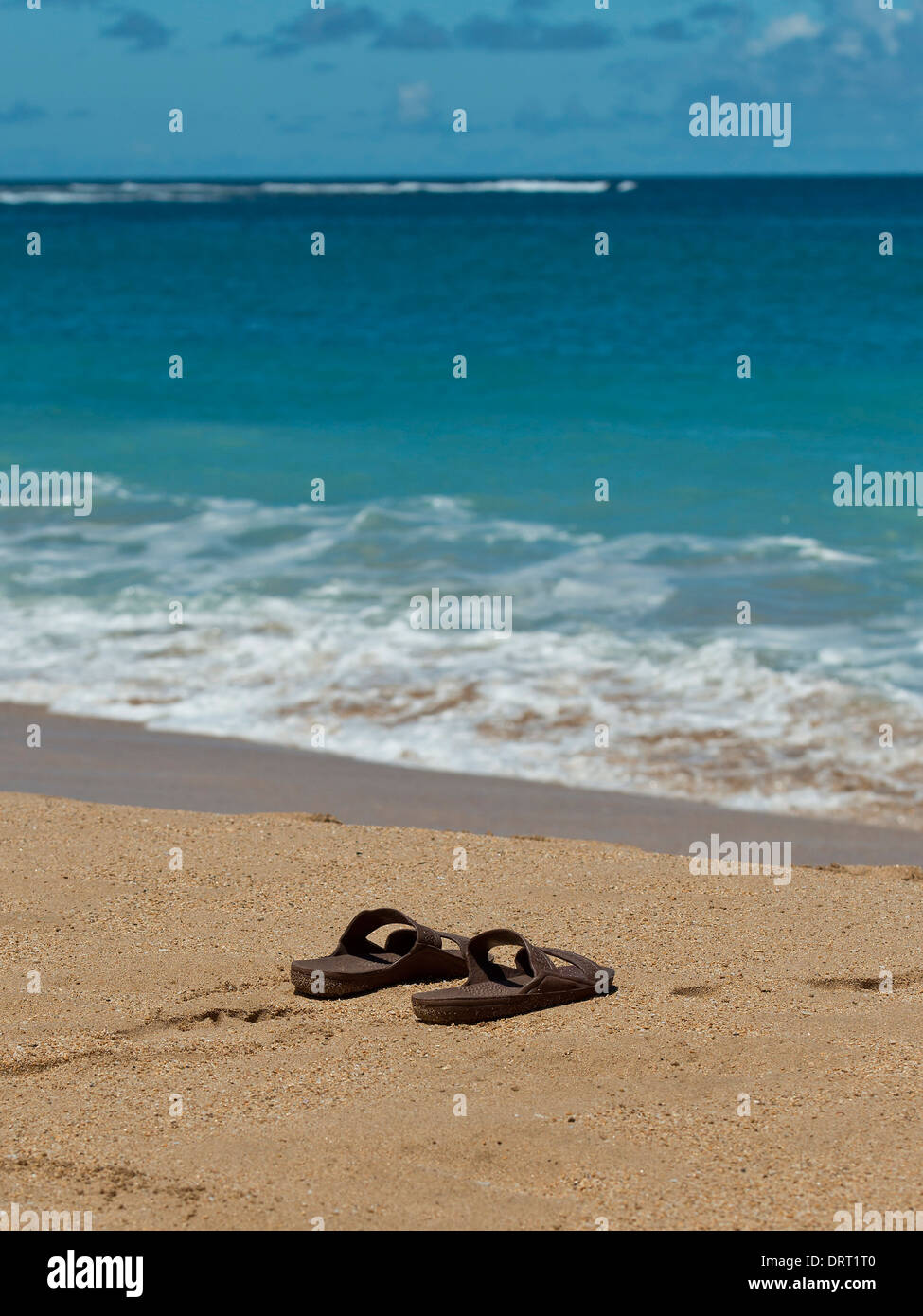 Sandals on the beach Stock Photo - Alamy