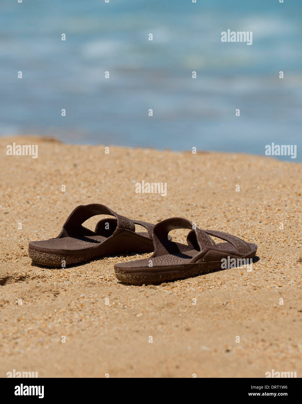 Sandals on the beach Stock Photo - Alamy