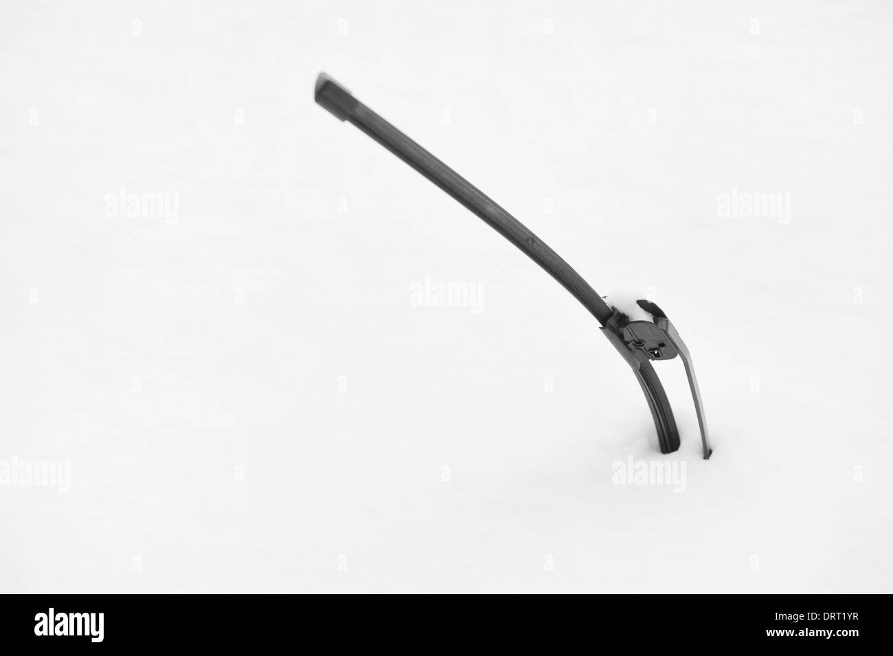 Windshield wiper of an snow covered car after heavy snowfall Stock Photo