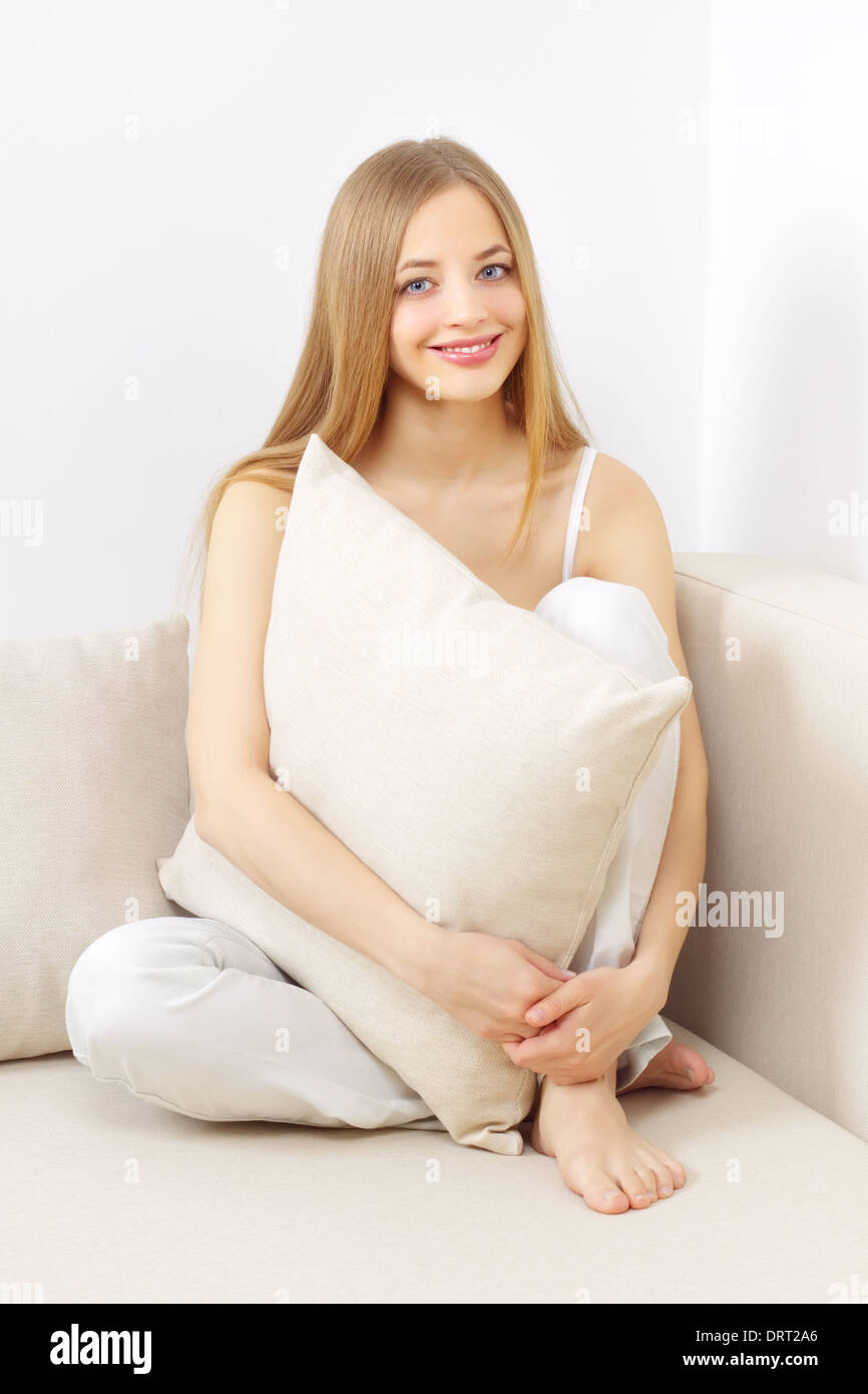 smiling girl sitting on sofa Stock Photo - Alamy