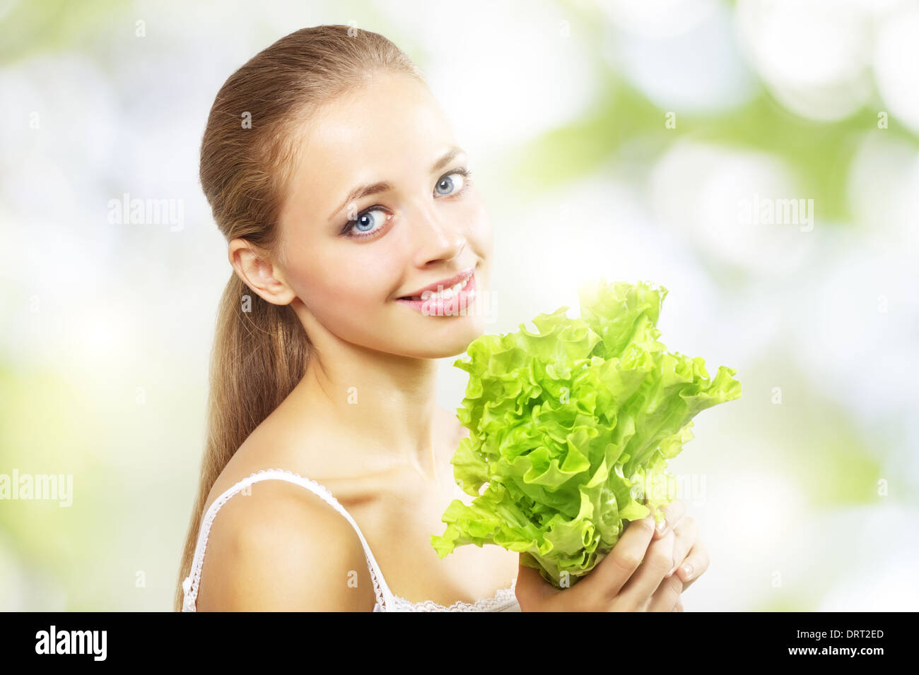 Girl with a fresh green lettuce leaf Stock Photo Alamy